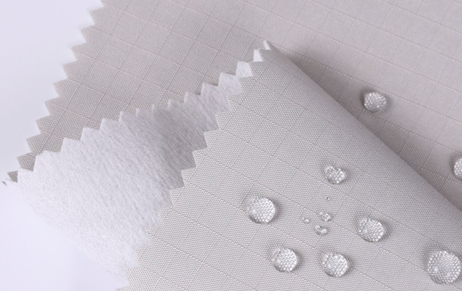 Best Fabric Type for Different Bags A collection of different bags made from Oxford fabric, like a backpack, a tote, and luggage