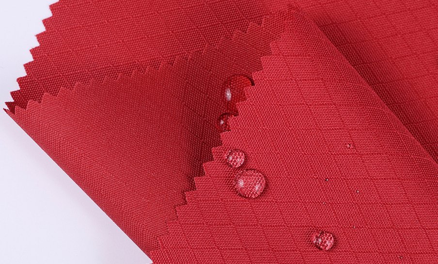 Comparing Bag Fabrics: Nylon vs Polyester vs Oxford A comparison of different fabric swatches like nylon, polyester, and Oxford cloth